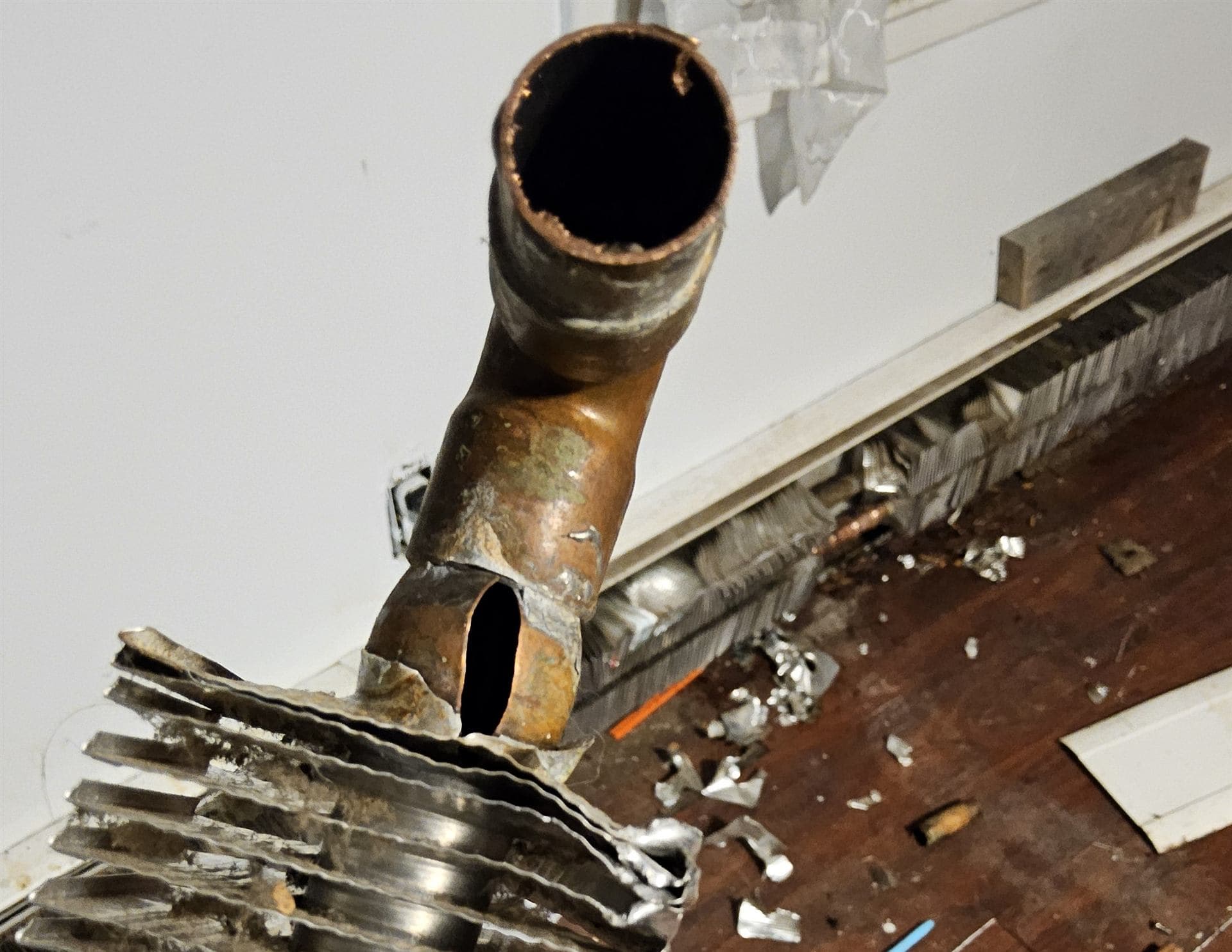 Freeze-split copper baseboard heating element removed during an emergency repair