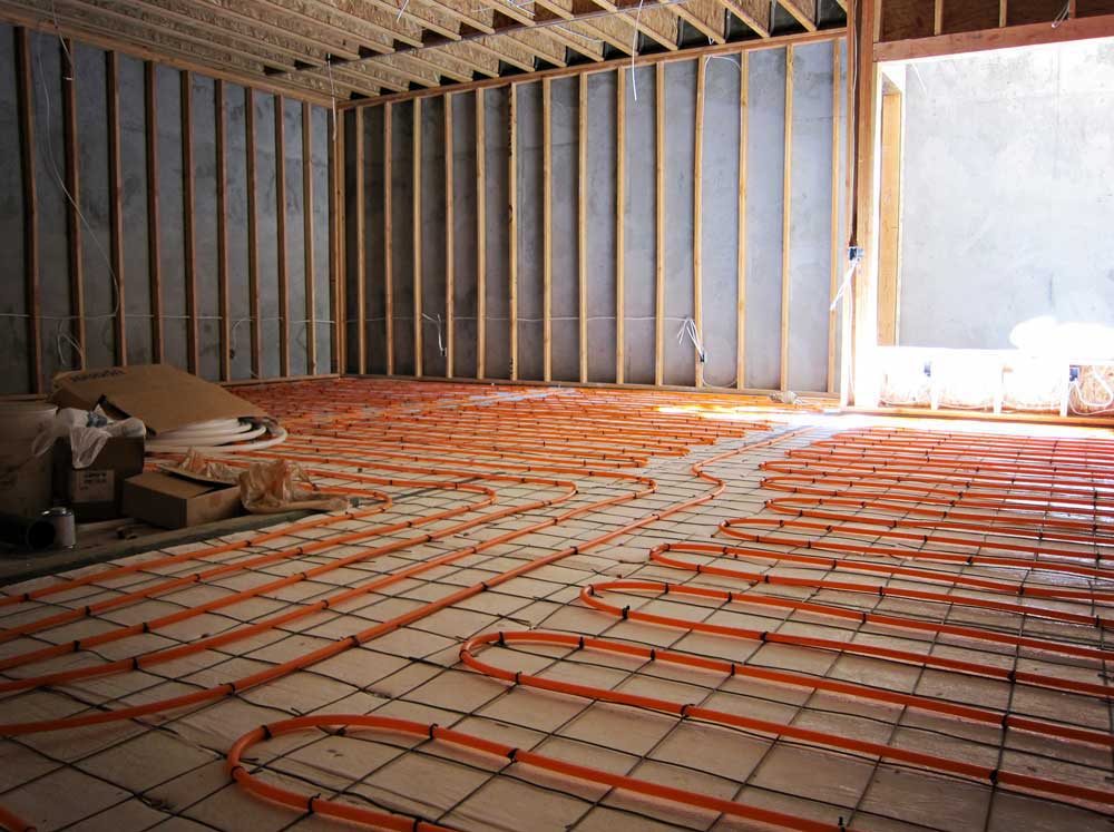 Hydronic radiant-heating tubing laid across the floor of a room under construction