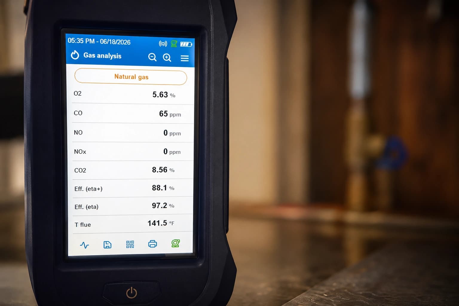 Handheld combustion analyzer screen showing a gas analysis readout.